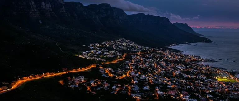Cape Town's coastline lit up at dusk, seen from Lion's Head