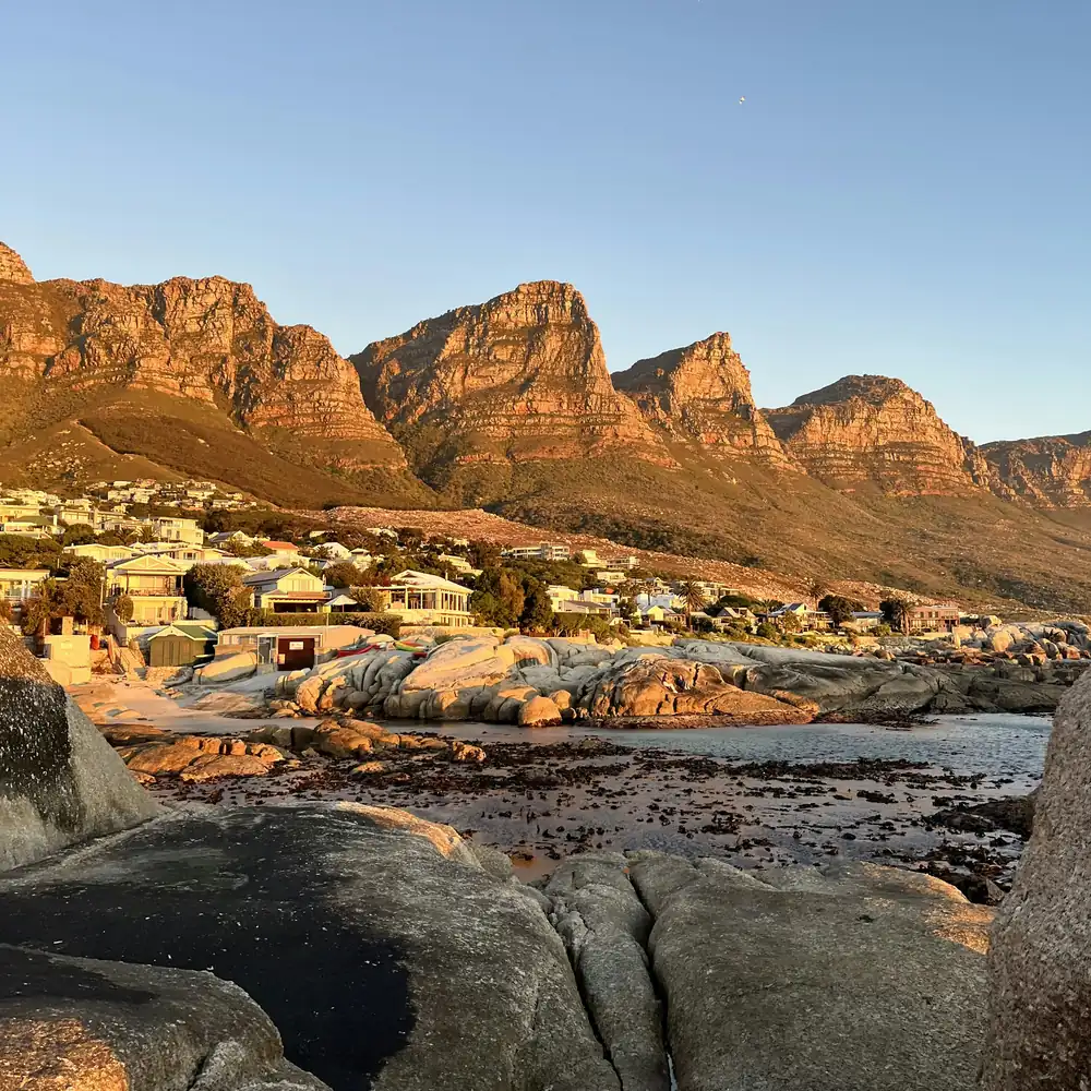 Golden morning light over Bakoven's mountains and rocky shore