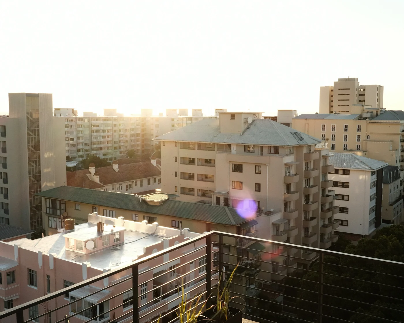 A quiet balcony overlooking a city at evening
