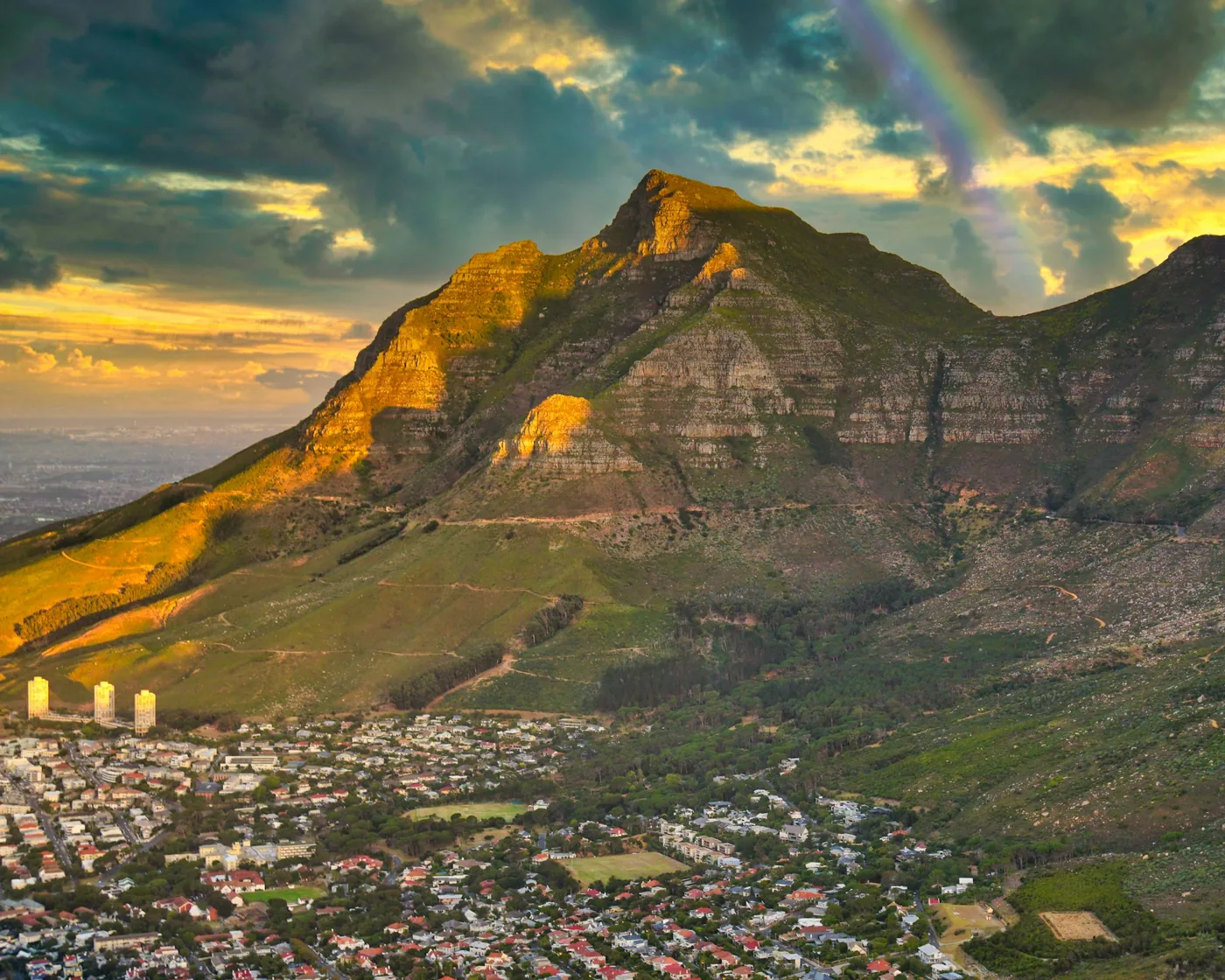 Golden evening light and a rainbow over Devil's Peak, Cape Town