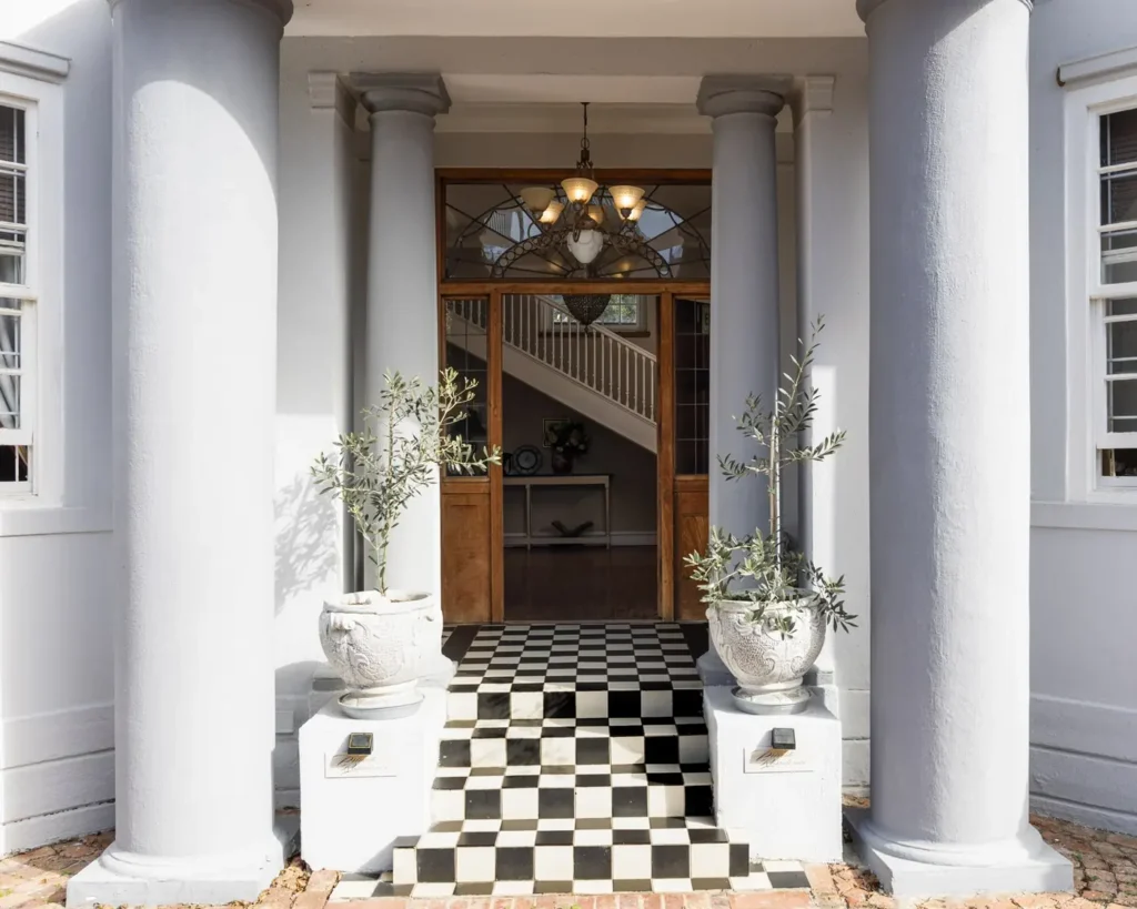 The pillared front entrance of the centre, with a chequered floor leading to the hall and staircase