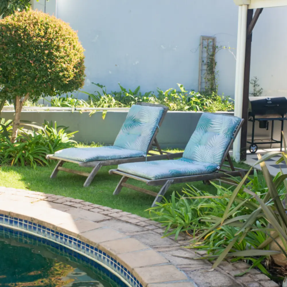 Two garden loungers by the swimming pool at the centre in Lakeside