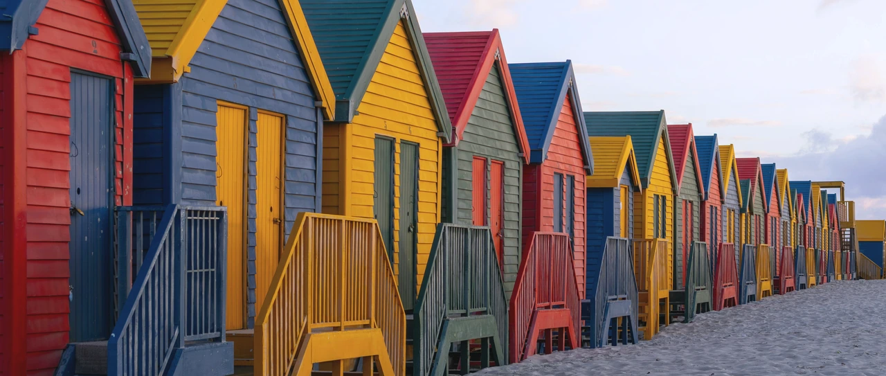 Colourful beach huts on the sand at Muizenberg, Cape Town