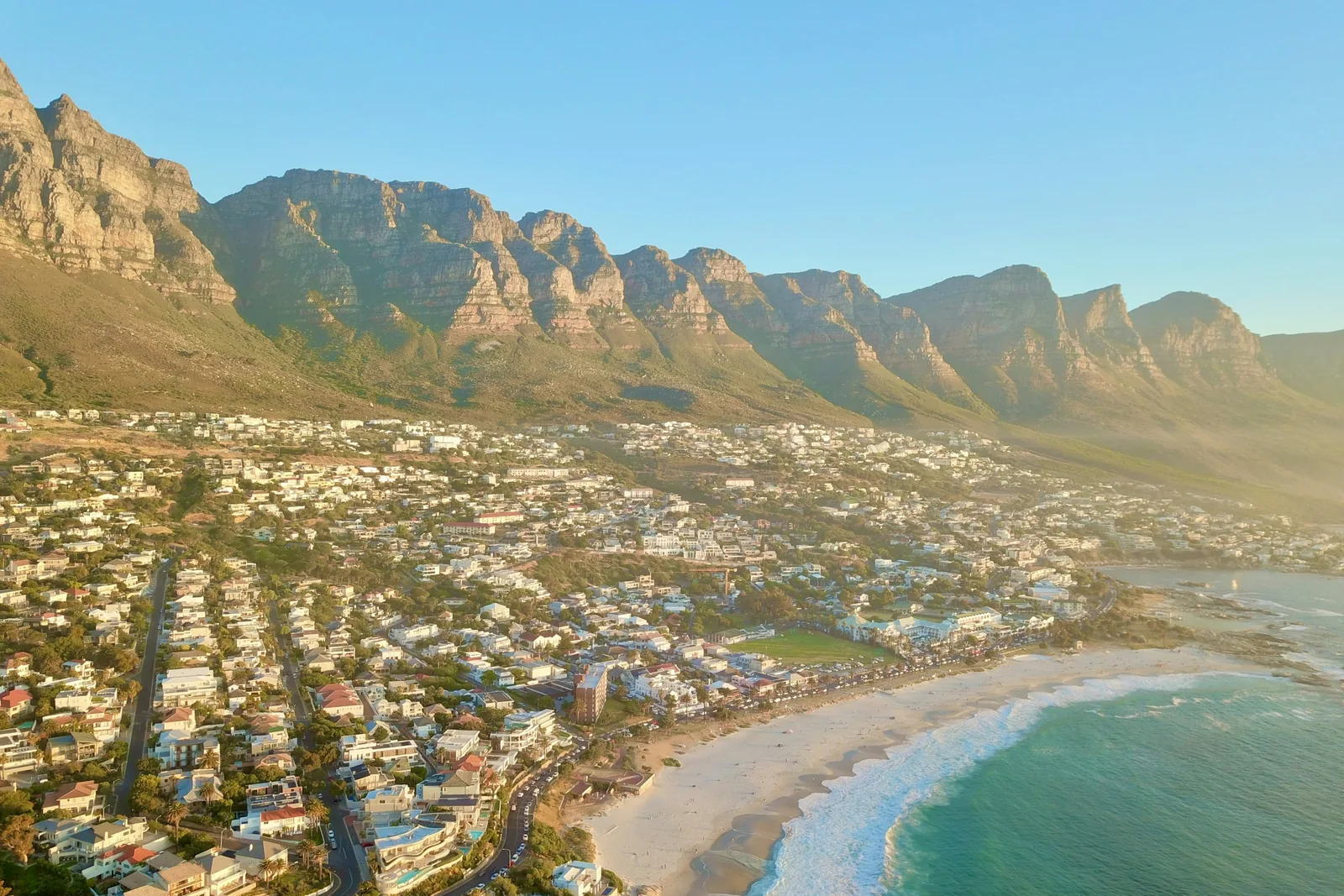 Table Mountain's flat rock face rising above Cape Town under a clear blue sky