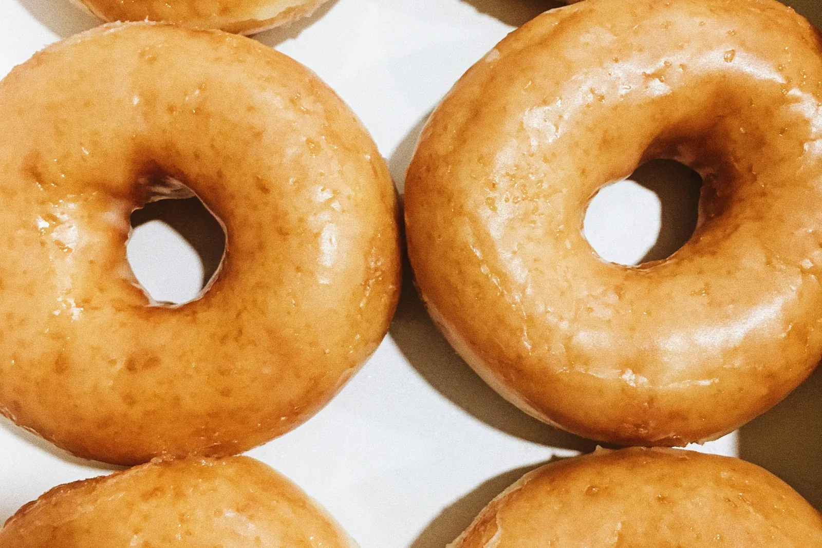 Glazed doughnuts in a box seen from above